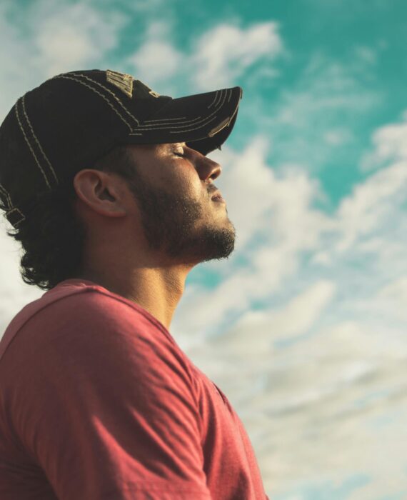 Man sitting with eyes closed, quietly reflecting, symbolizing a personal moment of clarity before recovery—not a dramatic rock bottom.
